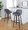 Daniella 30" Contemporary Fixed-Height Barstool with Swivel in Walnut Glazed Wood and Grey Faux Leather with Round Black Metal Footrest- Set of 2 — lifestyle photo 2