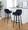 Daniella 30" Contemporary Fixed-Height Barstool with Swivel in Walnut Glazed Wood and Black Velvet with Round Black Metal Footrest- Set of 2 — lifestyle photo 1