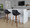 Fabrico Contemporary 30" Fixed-Height Barstool with Swivel in Walnut Wood and Black Faux Leather with Round Black Metal Footrest- Set of 2 — lifestyle photo 1