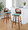 Folia bar stool in Black Metal, Walnut Wood, Teal Fabric, featuring swivel and wood frame