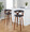 Gardenia 30" Mid-Century Modern Fixed-Height Barstool with Swivel in Walnut Wood and Charcoal Fabric with Round Chrome Metal Footrest- Set of 2 — lifestyle photo 2