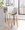 Gianna Mid-Century Modern Fixed-Height Barstool with Swivel in Walnut Wood and Light Grey Faux Leather with Round Chrome Metal Footrest- Set of 2 — lifestyle photo 2