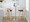 Grotto 30" Contemporary Fixed-Height Barstool with Swivel in Natural Wood and Brown Faux Leather with Round Chrome Metal Footrest- Set of 2 — lifestyle photo 1