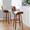 Lombardi bar stool in Walnut Wood, Black Metal, Cream PU, featuring swivel and upholstered seat
