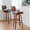 Lombardi bar stool in Walnut Wood, Black Metal, Grey PU, featuring swivel and upholstered seat
