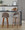 Renee bar stool in Walnut Wood, Brown Fabric, Black Metal, featuring wood frame