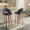 Renee Upholstered 30" Contemporary Fixed-Height Barstool with Swivel in Walnut Wood and Black Faux Leather with Round Chrome Metal Footrest- Set of 2 — lifestyle photo 1