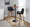 Santi 30" Mid-Century Modern Fixed-Height Barstool with Swivel in Walnut Wood and Black Faux Leather with Square Chrome Metal Footrest- Set of 2 — lifestyle photo 2