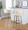 Toriano 30" Contemporary Fixed-Height Barstool with Swivel in Light Grey Wood and Cream Faux Leather with Round Black Metal Footrest- Set of 2 — lifestyle photo 1