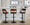 Cecina Contemporary Adjustable Barstool with Swivel in Black Metal, Walnut Wood, and Brown Faux Leather with Rounded T Footrest- Set of 2 — lifestyle photo 2