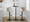 Cosi Mid-Century Modern Adjustable Barstool with Swivel in Black Metal, Light Grey Wood and Cream Faux Leather with Rounded T Footrest- Set of 2 — lifestyle photo 4