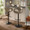 Curva Contemporary Adjustable Barstool in Black Metal and Light Grey Faux Leather with Rounded T Footrest- Set of 2 — lifestyle photo 3