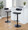Demi Contemporary Adjustable Barstool with Swivel in Black Metal, Chrome Metal and Black Faux Leather with Rounded T Footrest- Set of 2 — lifestyle photo 2