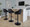 Fabrico Contemporary Adjustable Barstool with Swivel in Black Metal and Black Faux Leather with Rounded T Footrest- Set of 2 — lifestyle photo 2