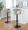 Gardenia table in Whitewashed Wood, Black Metal, Light Grey Fabric, featuring swivel and upholstered seat