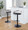 Grotto Contemporary Adjustable Barstool with Swivel in Black Metal, Light Grey Wood and Black Faux Leather with Rounded T Footrest- Set of 2 — lifestyle photo 1