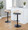 Grotto Contemporary Adjustable Barstool with Swivel in Black Metal, Natural Wood and Grey Faux Leather with Rounded T Footrest- Set of 3 — lifestyle photo 2