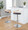 Grotto Contemporary Adjustable Barstool with Swivel in Chrome Metal, Natural Wood and Brown Faux Leather with Rounded T Footrest- Set of 3 — lifestyle photo 1