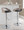Grotto Contemporary Adjustable Barstool with Swivel in Chrome Metal, Light Grey Wood and Black Faux Leather with Straight T Footrest- Set of 2 — lifestyle photo 1