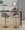 Renee Contemporary/Glam Adjustable Barstool with Swivel in Gold Metal and Dark Grey Fabric with Round T Footrest- Set of 2 — lifestyle photo 2