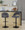 Renee Contemporary Adjustable Barstool with Swivel in Black Metal and Dark Grey Fabric with Round T Footrest- Set of 2 — lifestyle photo 1