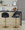 Renee Contemporary/Glam Adjustable Barstool with Swivel in Gold Metal and Black Faux Leather with Round T Footrest- Set of 2 — lifestyle photo 1