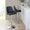Studded Marcel Contemporary Adjustable Barstool in Chrome Metal and Black Faux Leather with Chrome Nailhead Trim and Rounded T Footrest- Set of 2 — lifestyle photo 1