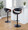 Curvo table in Black Metal, Walnut Wood, Black PU, featuring swivel and adjustable height