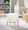 Michelle Contemporary Ottoman in Natural Wood and Cream Fabric — lifestyle photo 1