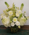 Vase of an assortment of white flowers.