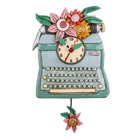 Clock, typewriter, retro, whimsical,  measures 14″ x 8″, hand-painted leaf hands, swinging flower pendulum,  cast in resin, finished by hand,  requires “AA” battery, designed by artist Michelle Allen 