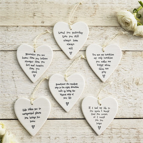 These hanging heart ornaments are made of porcelain, and each features a sweet phrase. 
Loved you yesterday. Love you still. Always have, always will. 
Remember you are braver than you believe, stronger than you feel and smarter than you think.
You are my sunshine, my only sunshine, you make me happy when skies are grey. 
Sometimes the smallest step in the right direction ends up being the biggest step of your life
Life takes you to  unexpected places, love brings you home
If I had my life to live again I would find you sooner so I could love you longer