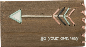 A wooden block lending a distressed "Go Your Own Way" sentiment with hand-stitched feathered arrow accents with single sitched border details. 
Contains strong back magnet or can free-stand alone.