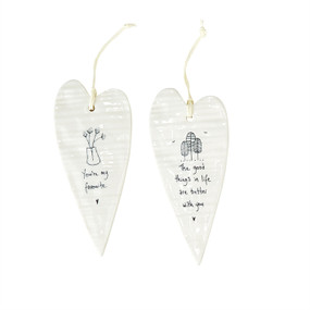 These long hanging heart ornaments are made of porcelain, and each features a sweet phrase. 
you're my favorite.
the good things in life are better with you.
how wonderful life is with you in the world.
in a world where you can be anything, be yourself.
love makes a house into a home.
always remember you are loved.
never give up, great things take time.
families are the heart of every home.
Size:  2 1/2" x 5 1/4" 