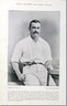 John James Lyons, Australian cricket photograph portrait-in-studio, in cricket whites, open casual collar, seemingly perched on a stone wall, looking at us complete with mustache, right thumb nonchalantly hooked into pants pocket, and bat in left hand, celebrated All-rounder, Antique photogravure, 1897