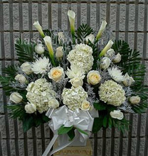 Medium size sympathy arrangement with hydrangeas and roses 