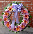 Medium size standing wreath with purple roses 
