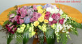Medium size closed casket spray with bright flowers 