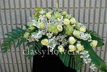 Small size casket spray with mixed flowers 