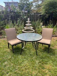 Bronze finish glass top bistro table and two outdoor parsons chairs