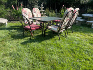 Bronze painted glass top patio set with six stackable chairs and cushions