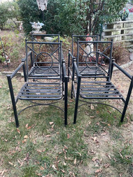 set of four black iron patio chairs