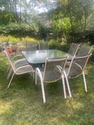 Bronze 8 person table and white sling patio chairs