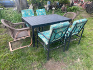 Black painted cast steel Hampton Bay patio dining set with 4 rocking chairs and cushions and 2 faux wicker chairs