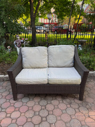 Faux wicker patio loveseat with cushions