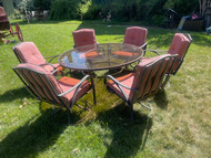 60” bronze finished round glass top patio table with six swivel chairs