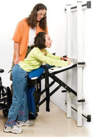 User is wheeled to Support Station, grabs the handholds, and lifts (is lifted) to standing position. When kneeboard is in place (shown in picture), a rolling commode can be moved in. When kneeboard is not used, the Support Station can be pivoted to a standing toilet. Or the client can be diapered with greater ease and better hygiene.