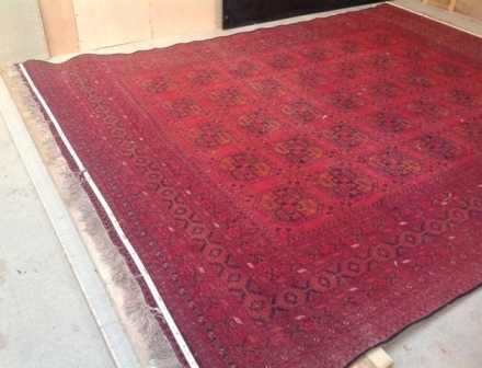 mis-shapen-afghan-rug-being-stretched-into-shape-web.jpg