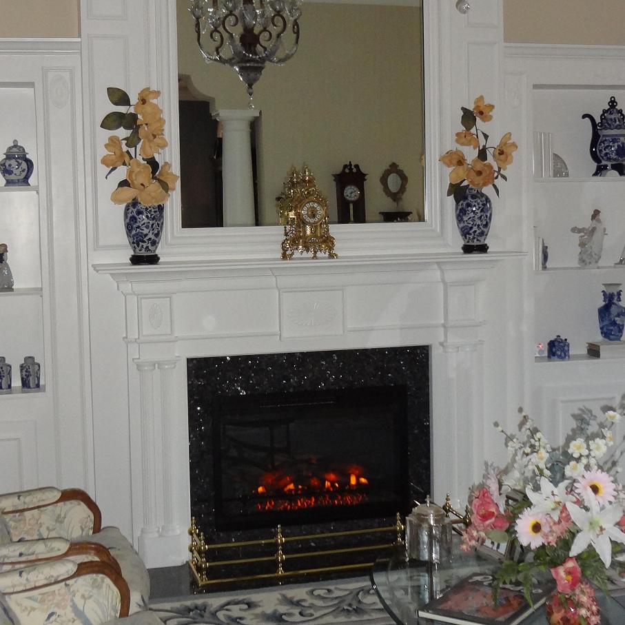 A colonial style fireplace mantel painted white