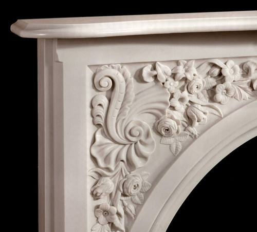 The Andrea marble mantel has beautiful floral details in the corners